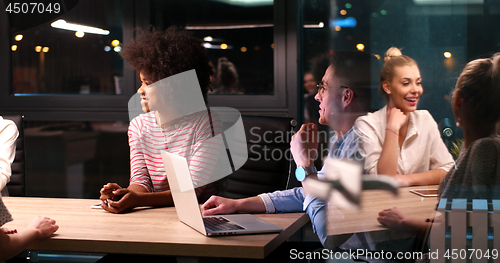 Image of Multiethnic startup business team in night office