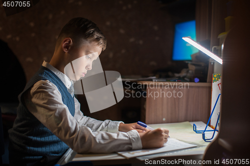Image of pupil boy does his homework