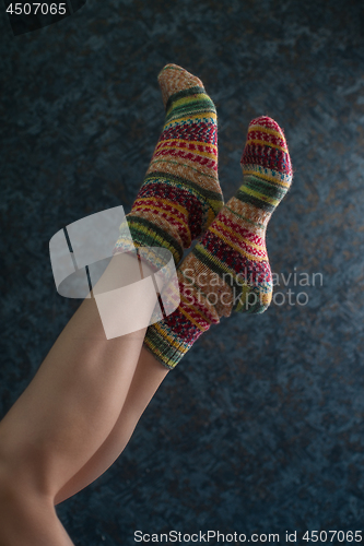 Image of Woman legs in wool knitted socks