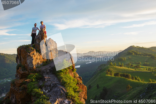 Image of Happy man and woman on top mountain