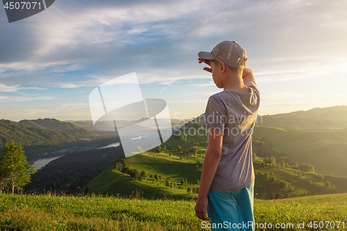 Image of Young explorer at the sunset