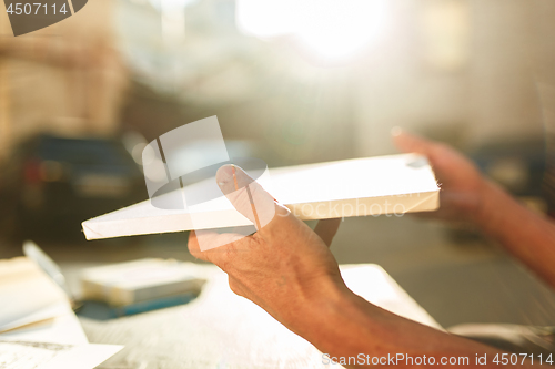 Image of Close up man working of Architect sketching a construction project on his plane project at site construction work