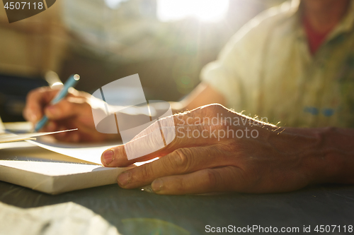 Image of Close up man working of Architect sketching a construction project on his plane project at site construction work