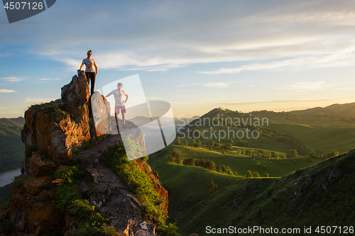 Image of Happy man and woman on top mountain