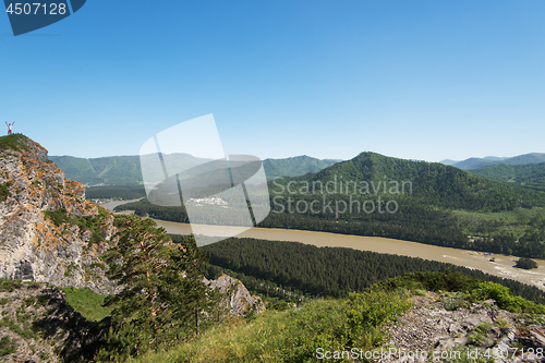 Image of Man standing on top of cliff