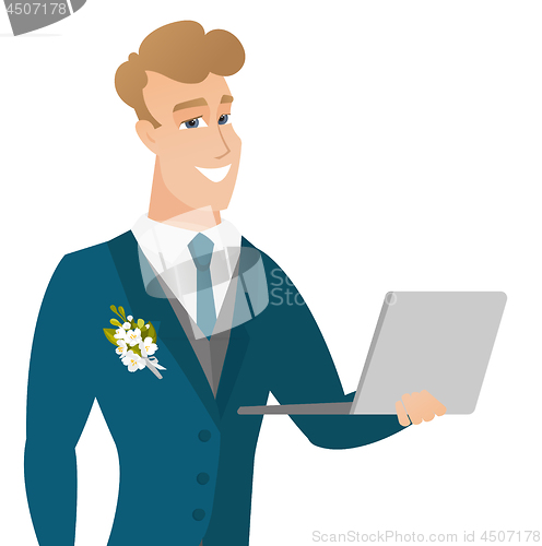 Image of Young caucasian groom using a laptop.