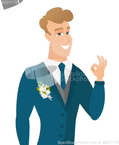 Image of Young caucasian groom showing ok sign.