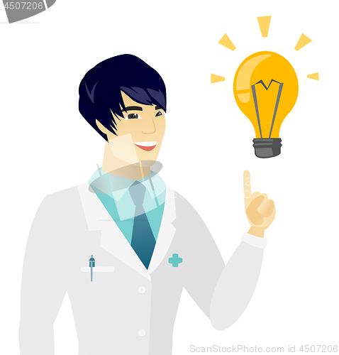 Image of Young asian doctor pointing at idea light bulb.