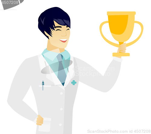 Image of Young asian doctor holding a golden trophy.