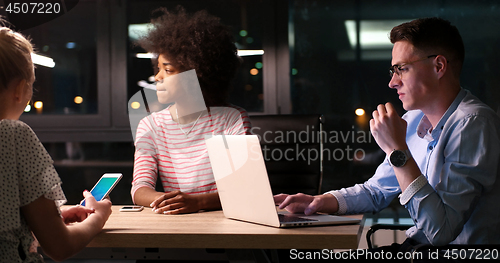 Image of Multiethnic startup business team in night office