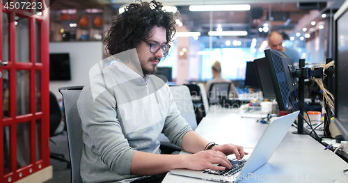 Image of businessman working using a laptop in startup office