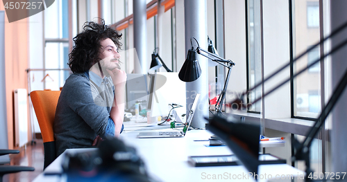 Image of businessman working using a laptop in startup office