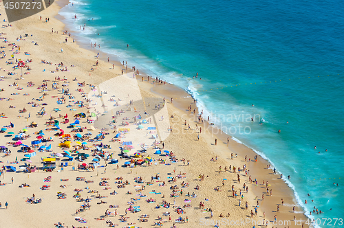Image of Crowded ocean beach. Nazare, Portugal