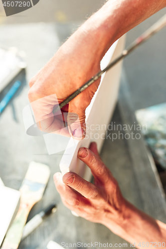 Image of Close up man working of Architect sketching a construction project on his plane project at site construction work