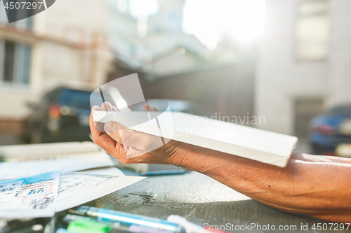 Image of Close up man working of Architect sketching a construction project on his plane project at site construction work