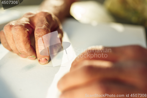 Image of Close up man working of Architect sketching a construction project on his plane project at site construction work