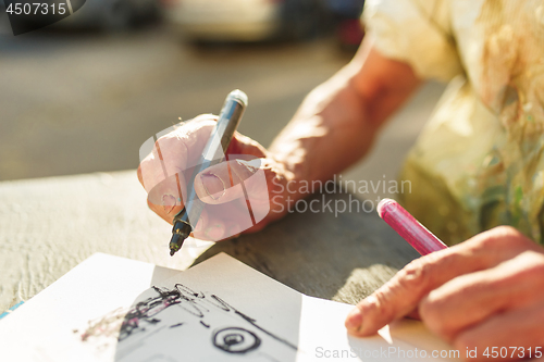 Image of Close up man working of Architect sketching a construction project on his plane project at site construction work