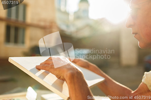 Image of Close up man working of Architect sketching a construction project on his plane project at site construction work