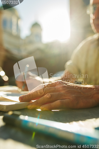 Image of Close up man working of Architect sketching a construction project on his plane project at site construction work