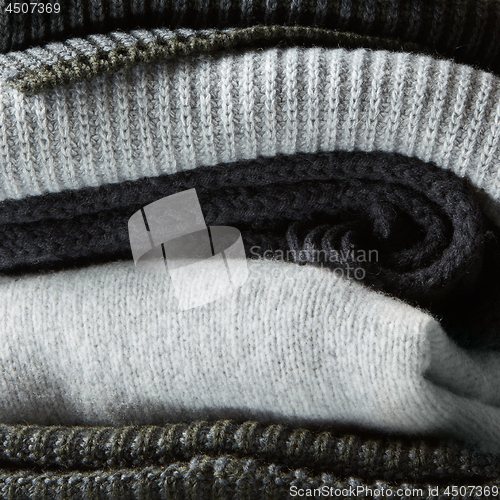 Image of Pile of knitted winter clothes on background