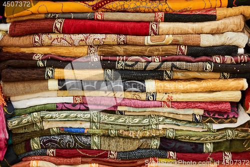 Image of Pile of colorful folded textile. Heap of cloth fabric