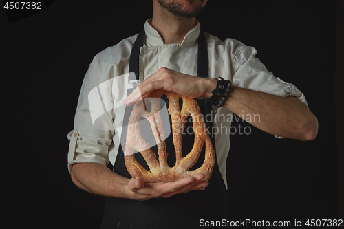 Image of Hands men holding fougas bread