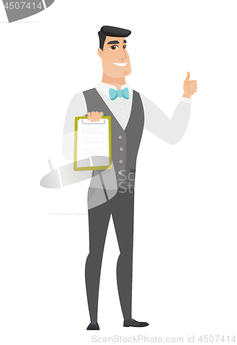 Image of Groom with clipboard giving thumb up.