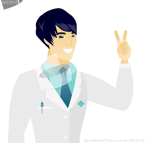 Image of Young asian doctor showing the victory gesture.