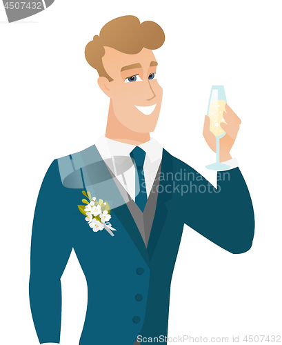 Image of Young caucasian groom holding glass of champagne.