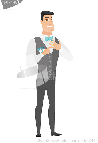 Image of Cheerful groom showing golden ring on his finger.