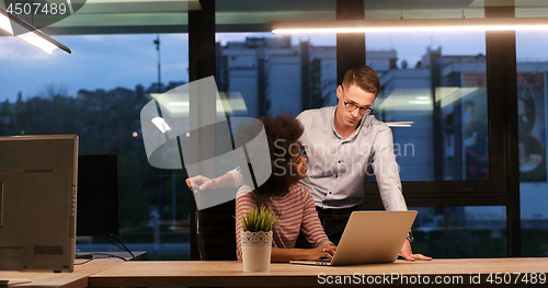 Image of Multiethnic startup business team in night office