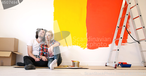 Image of Happy young couple relaxing after painting