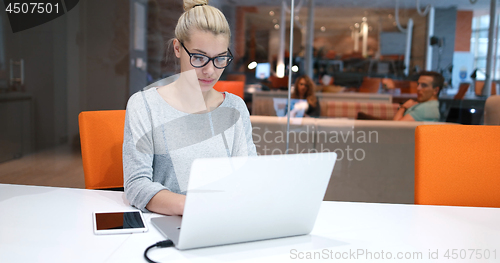 Image of businesswoman using a laptop in startup office