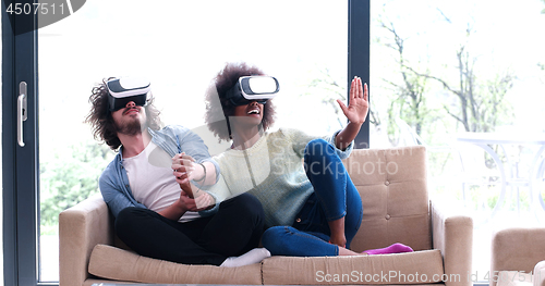 Image of Multiethnic Couple using virtual reality headset