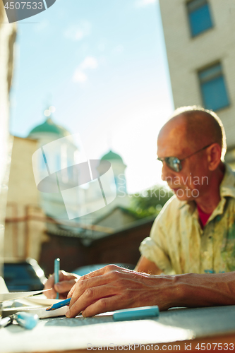 Image of Close up man working of Architect sketching a construction project on his plane project at site construction work