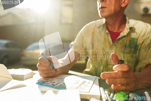 Image of Close up man working of Architect sketching a construction project on his plane project at site construction work