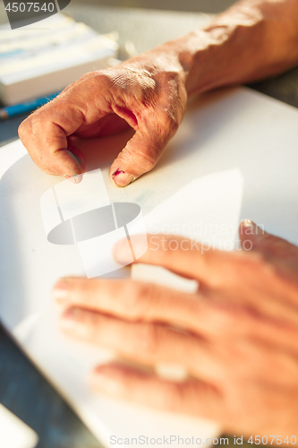 Image of Close up man working of Architect sketching a construction project on his plane project at site construction work