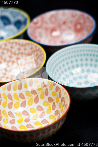 Image of Five colorful empty ceramic bowls.