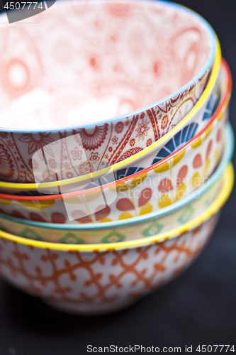 Image of Stack of colorful empty ceramic bowls closeup.