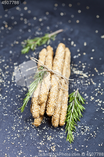Image of Italian grissini or salted bread sticks with sesame and rosemary
