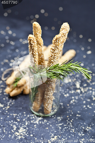 Image of Italian grissini or salted bread sticks with sesame and rosemary