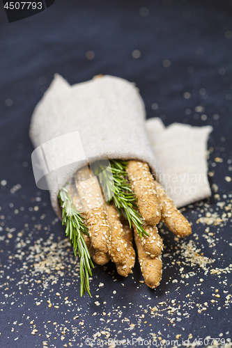 Image of Italian grissini or salted bread sticks with sesame and rosemary