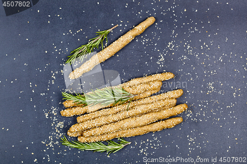 Image of Italian grissini or salted bread sticks with sesame and rosemary