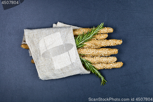 Image of Italian grissini or salted bread sticks with sesame and rosemary