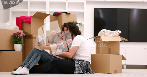 Image of young couple moving  in new house