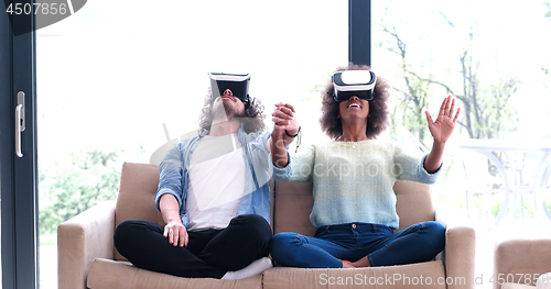 Image of Multiethnic Couple using virtual reality headset