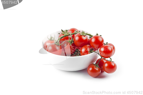 Image of Fresh organic cherry tomatoes bunch on ceramic bowl.