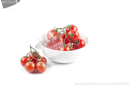 Image of Fresh organic cherry tomatoes bunch on ceramic bowl.