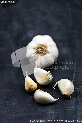 Image of Fresh raw organic garlic on black board.