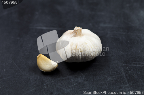 Image of Fresh raw organic garlic on black board.